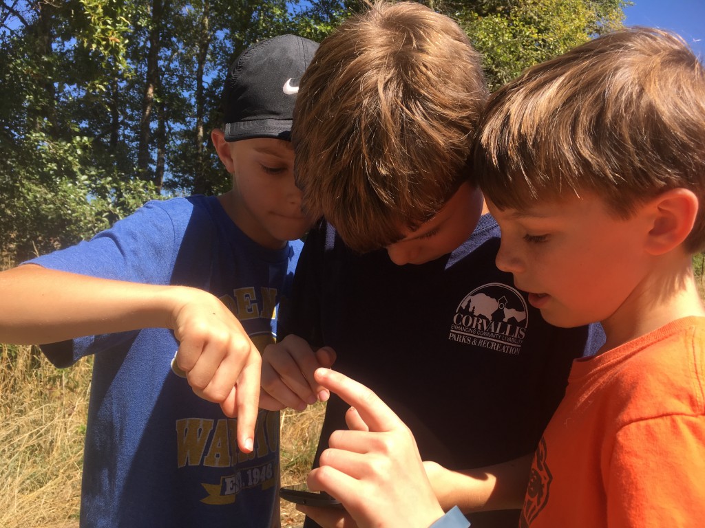 Kids work together to find Pokemon creatures and navigate the trails.